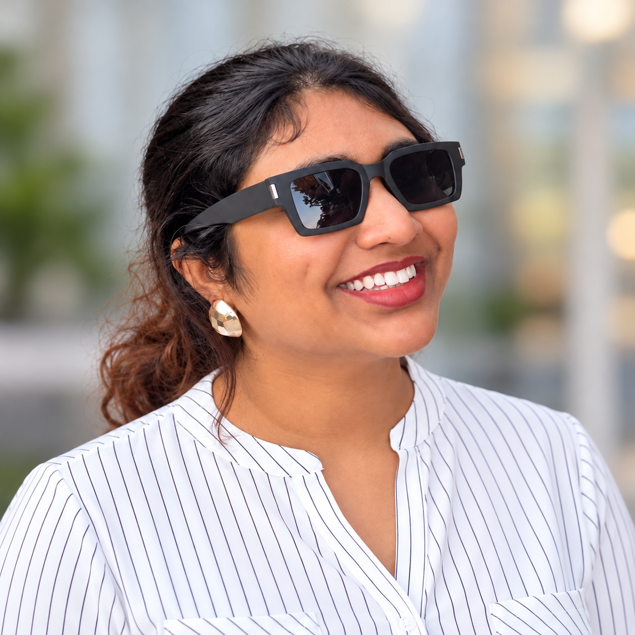 Manasa Narsupalli smiling in a striped blouse